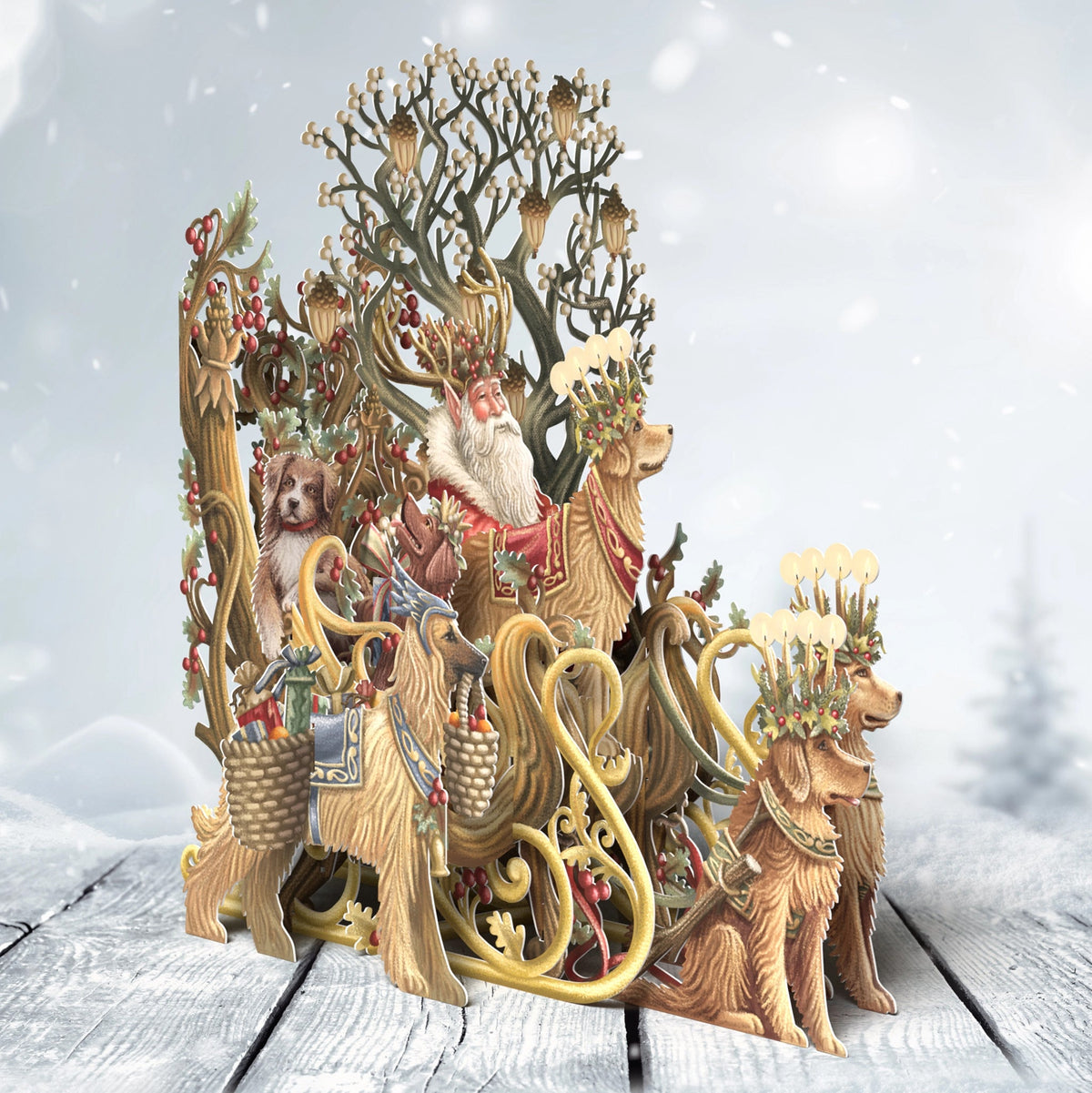 Santa’s Dog Sleigh pop-up Christmas card with Santa and golden dogs beside an ornate sleigh, displayed on snowy wooden boards.