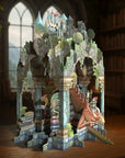 Fantasy castle pop up card with dragons and books on a wooden surface