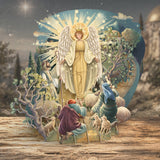 Decorative angel card with shepherds and sheep on a wooden surface