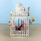 Flower Fairies play amongst flowers in laser cut paper birdcage