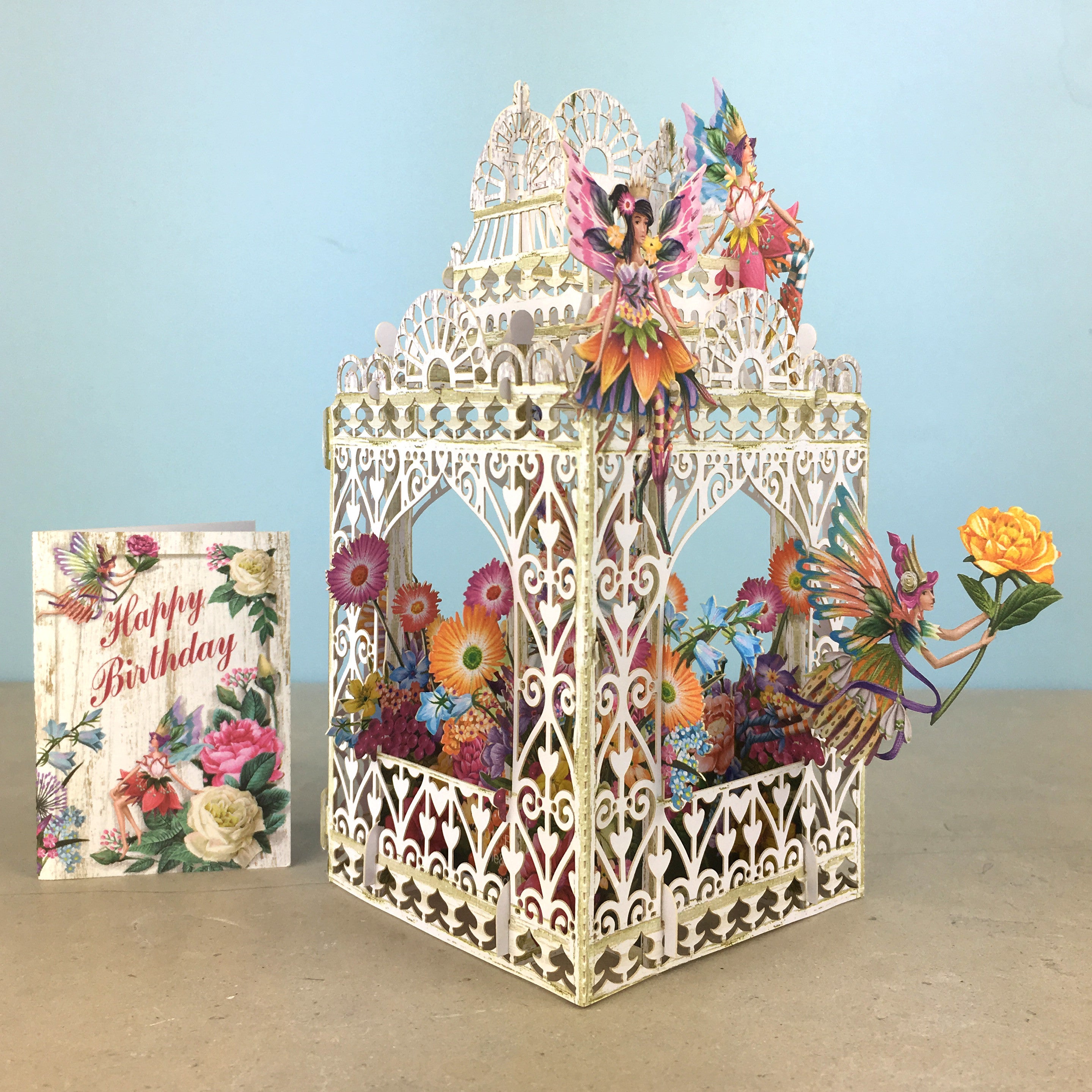 Flower Fairies play amongst flowers in laser cut paper birdcage by Me&amp;McQ