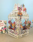 Flower Fairies play amongst flowers in laser cut paper birdcage by Me&McQ